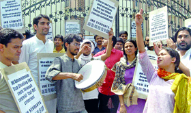JNU students demand immediate implementation of SC/ ST quota in jobs during a demonstration outside the University Grants Commission in New Delhi on Monday.