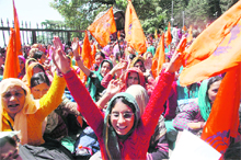 Anganwari workers shout slogans in support of their demands in front of the Vidhan Sabha during the session at Shimla on Monday.