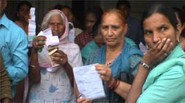 Consumers wait for the start of bill collection at the PSEB office in Nawanshahr on Monday.