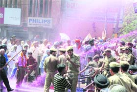 Policemen use water cannons on protesters belonging to the J&K PoK Refugees Front in Jammu