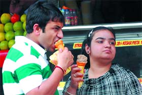 ICE ICE BABY: Two youngsters have ice-creams to beat the heat at Dhobi Bazaar in Bathinda on a hot Tuesday afternoon