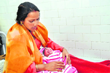 A mother with her child in Doon Womens Hospital in Dehradun on Tuesday.