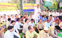 State government employees hold a dharna at the Gandhi Park in support of their demands in Dehradun 