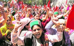 Activists of the Mid-day Meal Workers Union shout slogans in support of their demands in front of the Vidhan Sabha at Shimla on Tuesday. A Tribune photo