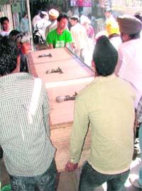 Shopkeepers remove their farries during a demolition drive at Akalgarh market in Ludhiana