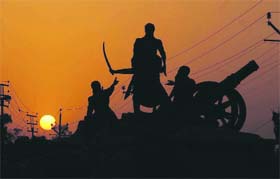 Statues installed at Bhai Ghanaiya Chowk in Bathinda with the sun setting in the backdrop