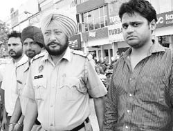 The accused in police custody.
