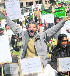 Dal Lake dwellers protest in support of their demand for rehabilitation in Srinagar on Wednesday.