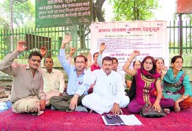Members of the Gram Pradhan Sangathan stage a dharna in Dehradun