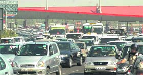 SIX LANES NOT GOOD ENOUGH: Vehicles move at a snails pace near Toll Plaza on the Delhi-Gurgaon highway