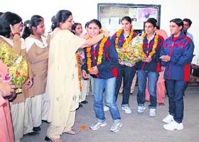 Members of the world cup winning Indian throw ball team being welcomed in their college in Sirsa