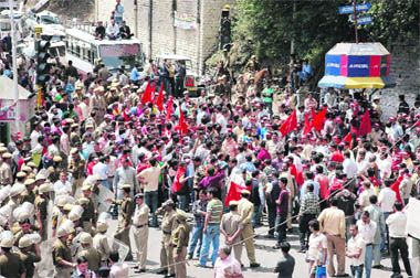 CPM workers block traffic in protest against price rise and hike in bus fares at Shimla on Thursday. 
