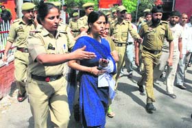 A striking government employee being arrested by the police from SMG Hospital in Jammu