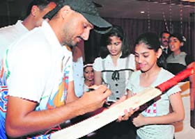 Bhajji signs a bat for a fan