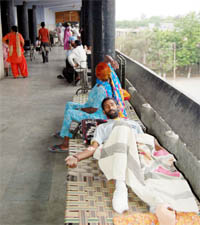 Due to inadequate infrastructure, patients lie on the cots arranged by themselves in the passage of orthopaedic unit III of Guru Nanak Dev Hospital in Amritsar.