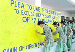 Students of Greenland School sign a mercy petition for the 17 Indian youths on death row in the UAE in Ludhiana on Friday.