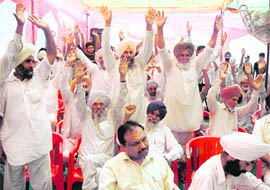 People of Gholia Kalan village in Moga district protest against a proposed cement plant in the village during a public hearing on Friday.