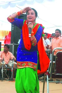 Punjabi singer Satwinder Kaur Bitti performing on the occasion