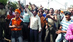 People protest against the demolition of a religious shrine during the anti-encroachment drive in Amritsar. Photo: Vishal Kumar