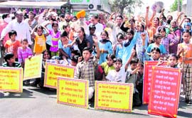 Students, parents protest against a liquor vend near a government school in Ludhiana on Saturday. Photo:Inderjeet Verma 