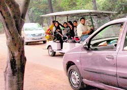 Visitors being taken around on an electric ferry at the Chhatbir zoo, while a number of private vehicles can also be seen zipping around. Tribune photo: Manoj Mahajan