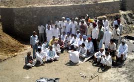 Farmers from tail-end villages sit on dharna inside the Malukpura distributary at the controversial cross-regulator point on Sunday. Photo: Raj Sadosh