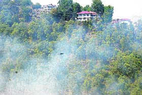 Indira Bhawan in the background of smoke in Mussoorie