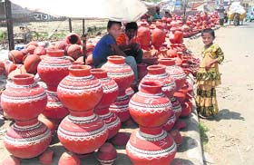 A vendor displays earthen water pots near Sector 14 in Karnal