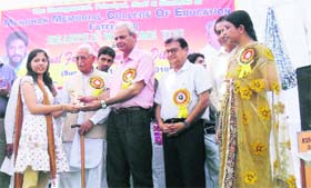 Chief Parliamentary Secretary PSGillankhera awards a student of MM College of Education in Fatehabad