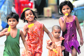 Children enjoy ice-cream on a hot summer day in Kolkata on Sunday. 