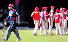 Delhi Daredevils Virender Sehwag walks back after being dismissed against Kings XI in New Delhi on Sunday.  PTI
