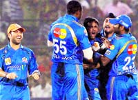 Mumbai Indians celebrate the fall of a wicket during their match against the Rajasthan Royals in Jaipur on Sunday.  PTI
