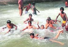With temperature rising across the region, boys beat the heat by playing in the Sirhind canal in Bathinda. 