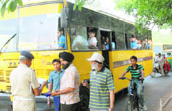 A school bus driver being challaned for not wearing proper uniform near the lights on the road separating Sectors 17 and 18 during a drive to check violations in Chandigarh