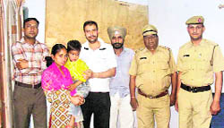 Sumit being united with his parents by two social workers and the local police at Kirti Nagar in Kurukshetra. Tribune photo