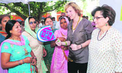 European Union climate action commissioner Connie Hedegaard receives handicraft items made by rural women of Gaganpur village, in Ambala district, during her maiden visit.