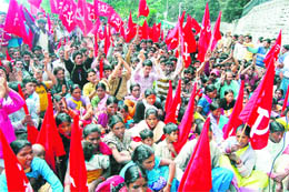 Labourers raise slogans at a protest organised by CITU in support of their demands in front of the Vidhan Sabha at Shimla on Monday. 
