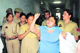 A striking health employee being arrested at the SMGS Hospital in Jammu