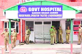 Policemen stand guard outside Government Hospital in Gandhi Nagar as employees struck work for the ninth day