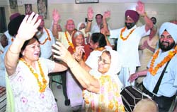 Inmates of old-age home celebrate Baisakhi in Ludhiana on Monday. 