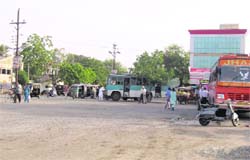 Buses are parked haphazardly on the roadside due to the absence of a proper bus stand at Fatehgarh Sahib. 