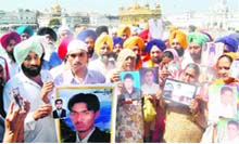 Members of the families of Indian youths, who are facing the gallows in the UAE, in the Golden Temple complex on Monday. 
