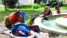 Due to a shortage of water, residents of railway quarters, near Gol Bagh, wash clothes near a fountain in Amritsar on Tuesday. 