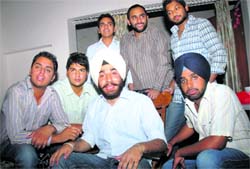 Harsher Singh (in white turban) flanked by his friends at his house in Sector 11 after he was fired upon at DAV College, Sector 10, Chandigarh, on Tuesday. Tribune photo: Pradeep Tewari