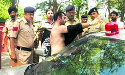 A youth comes out of his car at Tagore Theatre as cops look on. Tribune photo: Manoj Mahajan 