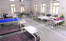 A patient rests on a bed inside an empty ward of the state-run SMHS Hospital during an indefinite strike by government employees in Srinagar.