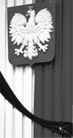 A Polish flag with a black ribbon attached is pictured during a memorial service at the Parliament building in Warsaw