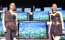 Models stand beside Toshiba's new high-definition LCD television series, "LED Regza" at the press preview in Tokyo on Wednesday. Toshiba will put the 19-inch to 55-inch "LED Regza" on the Japanese market from May.  AFP 