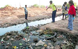 Children play amidst filth at Colony No. 5, Chandigarh