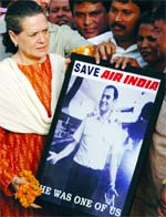 UPA chairperson Sonia Gandhi holds a portrait of 